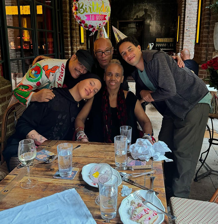 Group of people celebrating with party hats at a table, related to Robert De Niro's daughter transgender interview news. Group of people celebrating with party hats at a table, related to Robert De Niro's daughter transgender interview news.