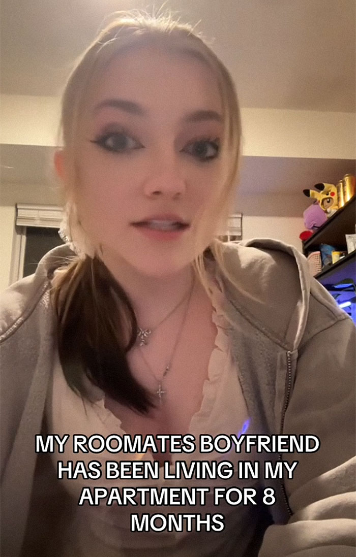 Young woman discussing roommate's boyfriend issues online, seeking advice.
