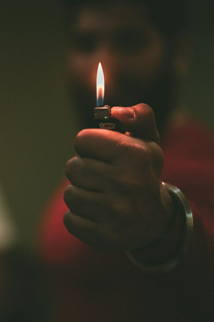 Hand holding a lit lighter symbolizing a memorable moment shared by first responders during a life-changing call.