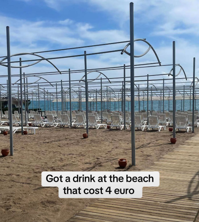 Beach view at a 5-star resort in Turkey with empty lounge chairs and message about a drink costing 4 euros. Beach view at a 5-star resort in Turkey with empty lounge chairs and message about a drink costing 4 euros.