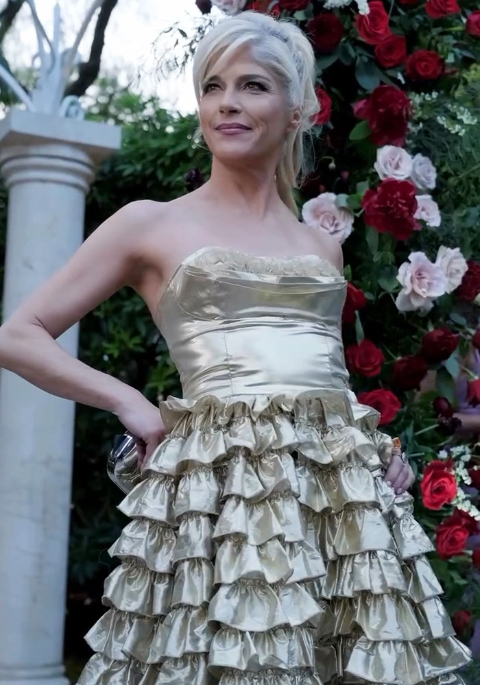 Selma Blair on the red carpet, wearing a gold ruffled dress, showcasing her amazing personality amidst floral backdrop. Selma Blair on the red carpet, wearing a gold ruffled dress, showcasing her amazing personality amidst floral backdrop.