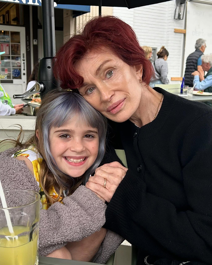 Grandmother and child smiling in a cozy restaurant setting, emphasizing family bond and genuine expressions.