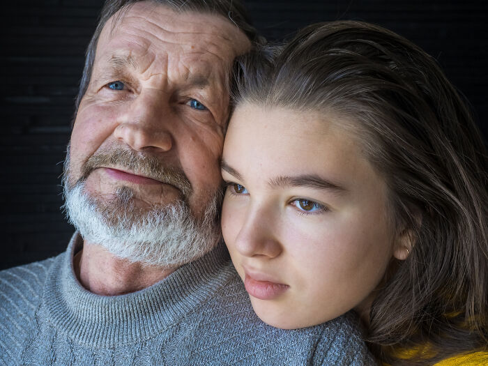 Older man and young person sitting closely, evoking complex emotions and potential psychopath vibes.