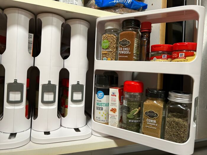 Innovative kitchen spice organizer with labeled jars for easy access and efficient storage.