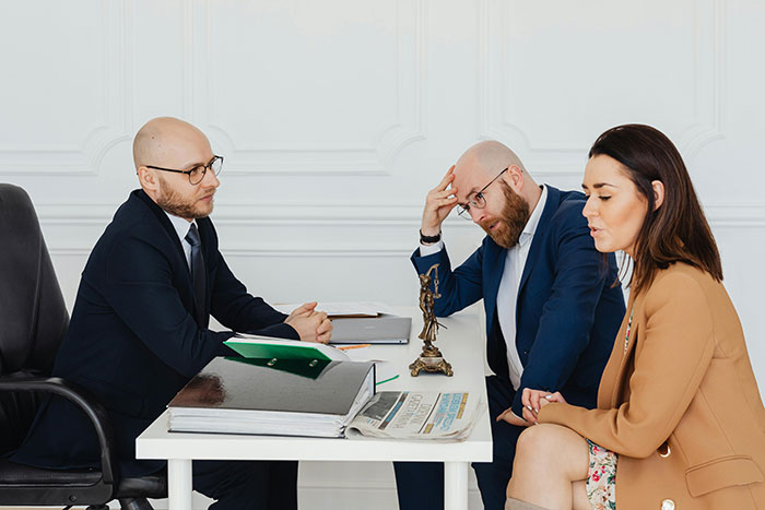Three people in a meeting discussing serious issues, with a focus on consequences of a stepmom's past affair.