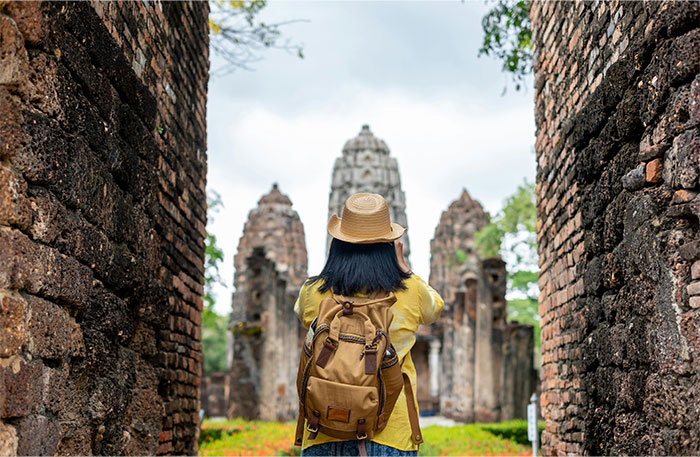 Traveler in a hat explores ancient ruins, showcasing an unbelievable coincidence in architecture.