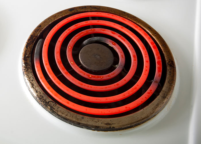 A hot electric stove burner glowing red.