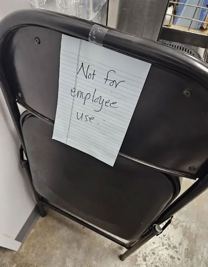 Chair with a note reading "Not for employee use," exemplifying infuriating bosses in the workplace.