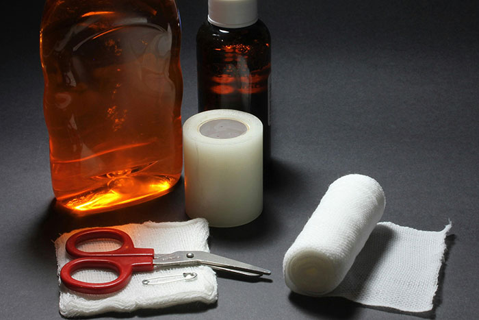 First aid supplies including bandages, antiseptic bottles, and scissors, essential lifesaver items.