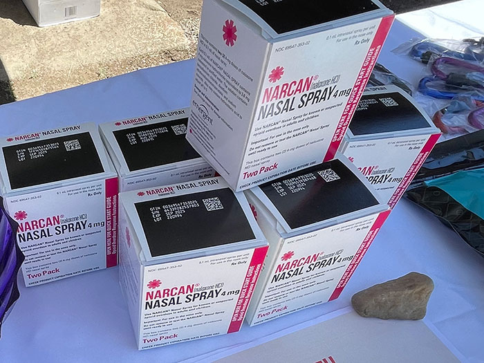 Narcan nasal spray boxes on a table, representing lifesaving medical solutions.