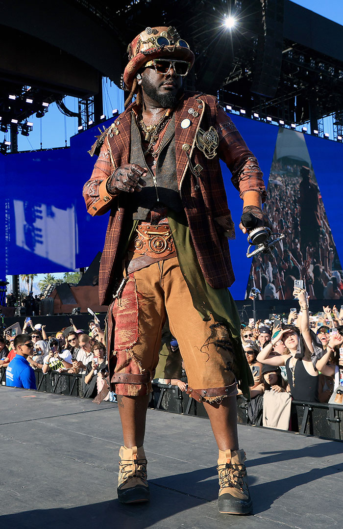 Celebrity in steampunk attire on stage at Coachella 2025, surrounded by a cheering crowd.