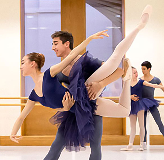 Ballet dancers practicing in a studio, showcasing inclusion of plus-size performers.