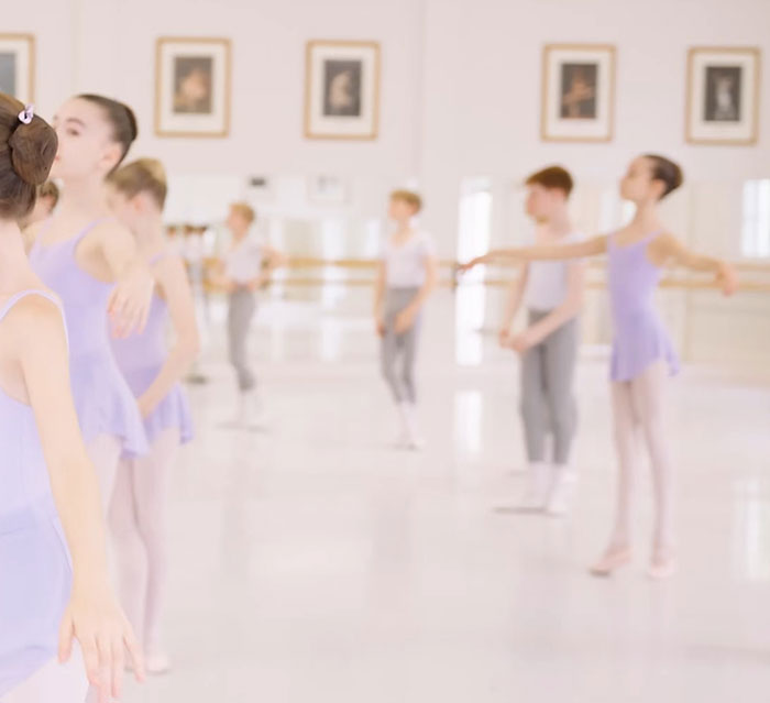 Ballet class at the Royal Ballet School, featuring dancers in a practice session, focusing on inclusivity.