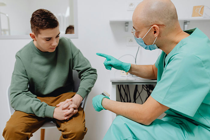A doctor discussing health safety with a patient in a clinic setting, highlighting life-changing precautions.
