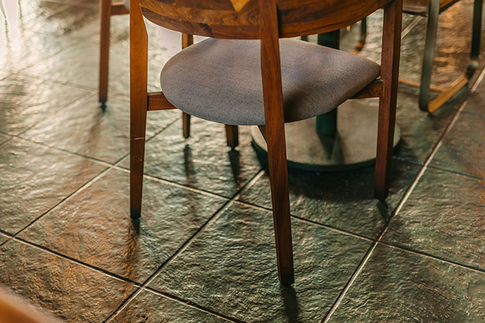 Dining chair on clean tile floor, ready for hosting guests.