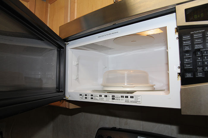 Open microwave showing interior cleanliness before hosting guests.