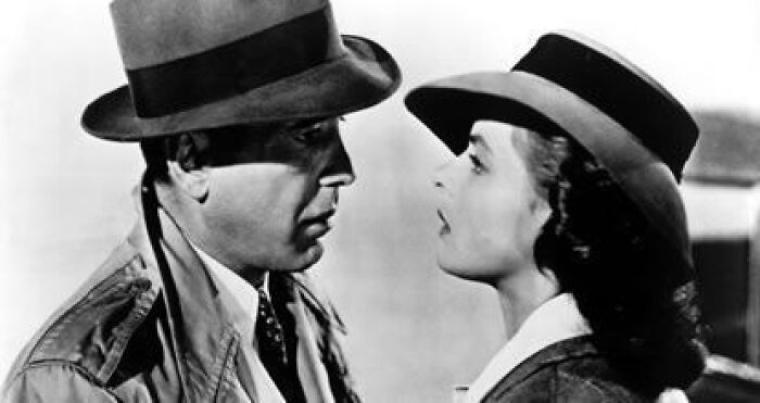 Two actors in a black and white film, wearing hats, in a dramatic scene known to cause tears.