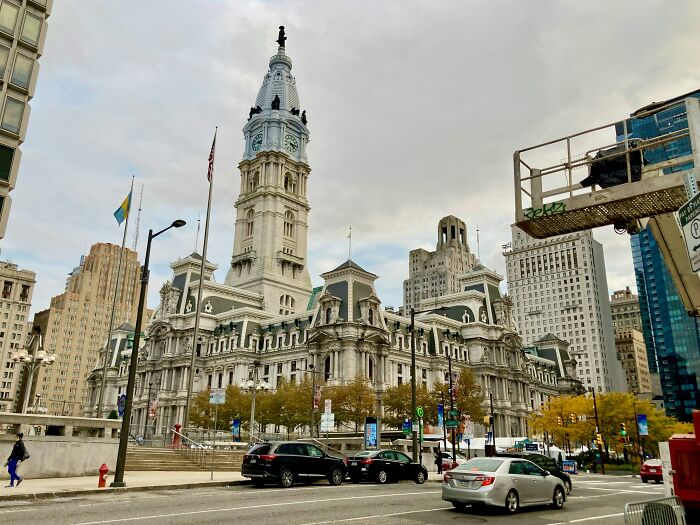 Historic city hall in a top US travel destination, showcasing iconic architecture, bustling street in summer.