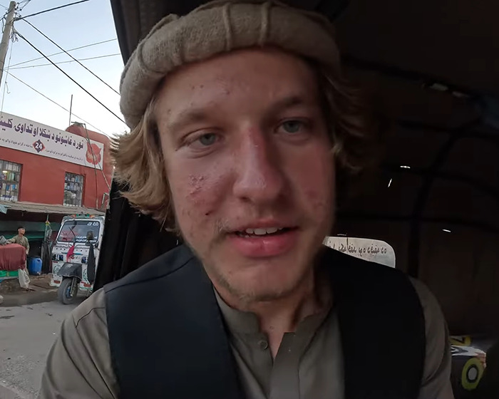 YouTuber in traditional attire, involved in Diet Coke stunt affecting isolated tribe, facing legal consequences.