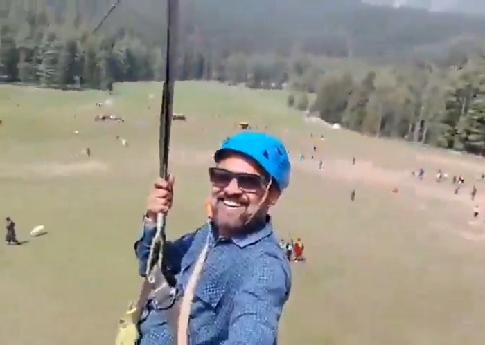 Man smiling on zip-lining adventure while a horrifying viral video captures a mass tragedy below taking multiple lives