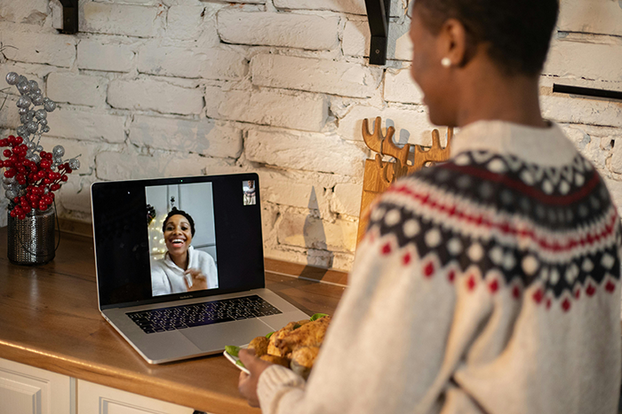 Person in a patterned sweater video chatting on a laptop, reflecting on their wife coming out as trans and coping emotions. Person in a patterned sweater video chatting on a laptop, reflecting on their wife coming out as trans and coping emotions.
