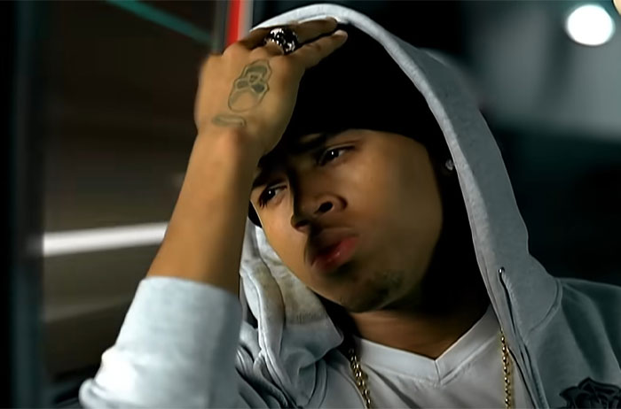 Person in a hoodie, appearing deep in thought, captured in an introspective moment.