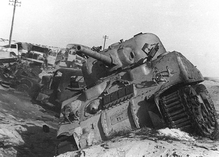 Wartime scene with damaged tanks and vehicles showing moments in history people may not realize were important.