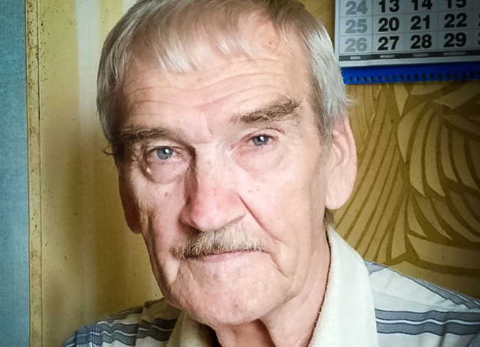 Elderly man with a striped shirt in a room, symbolizing important moments in history many overlook.