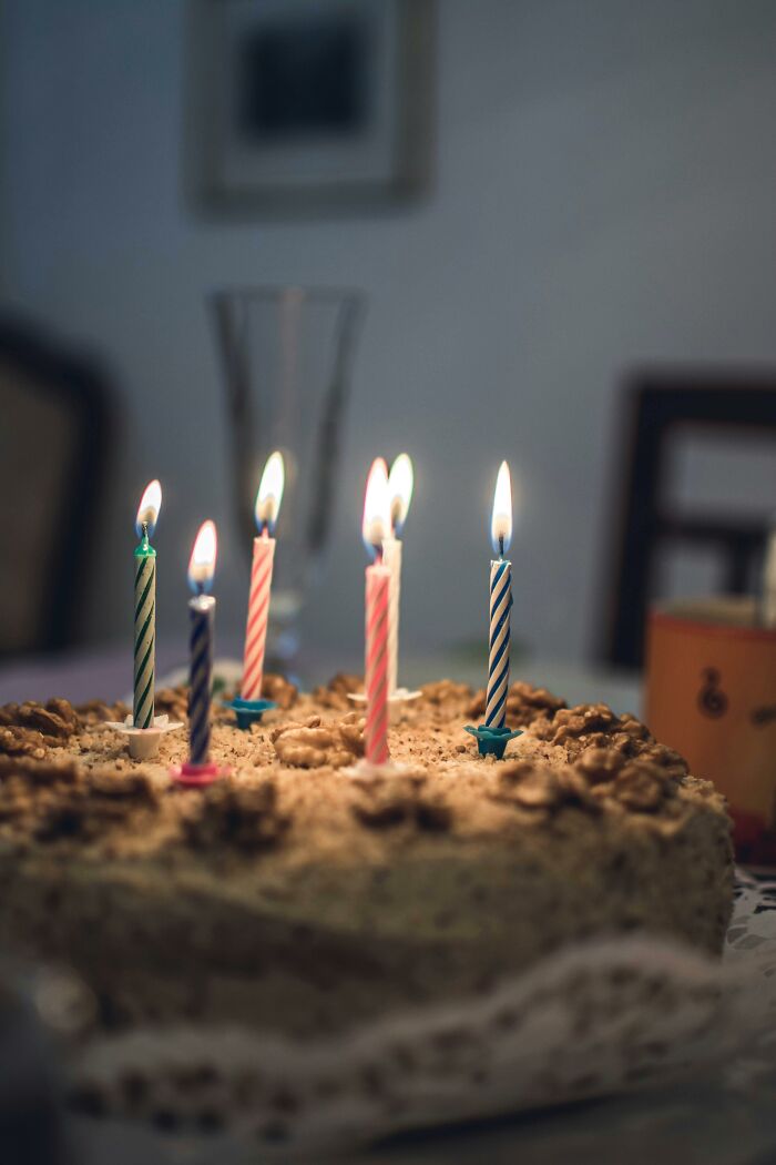 Birthday cake with lit candles, symbolizing moments that made people's exes blood boil to this day.