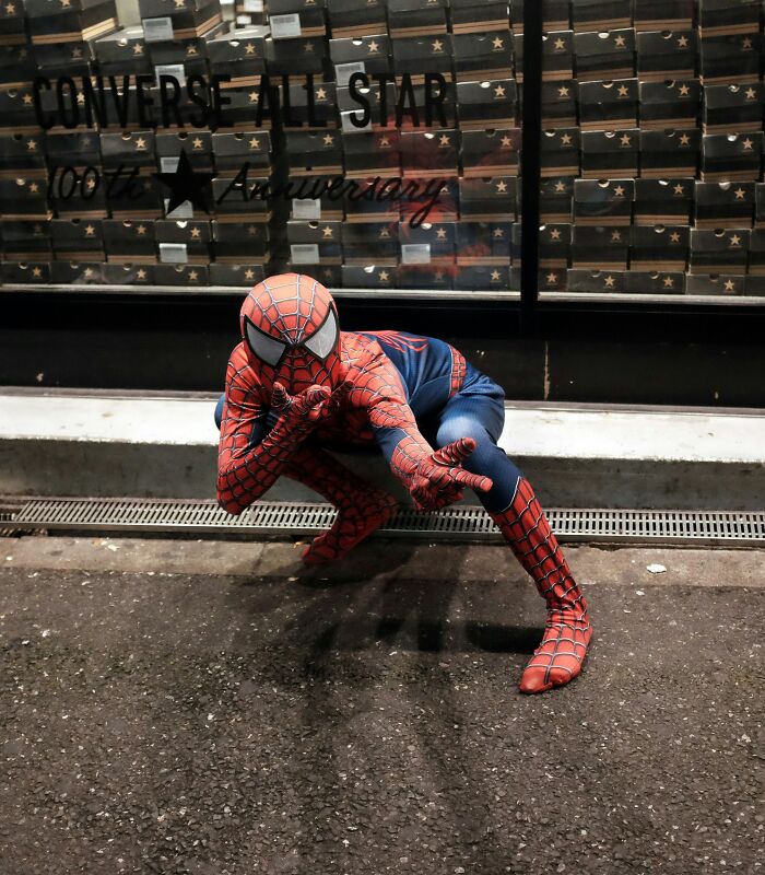 Person dressed as Spider-Man crouching on street, illustrating things exes did that still make people's blood boil.