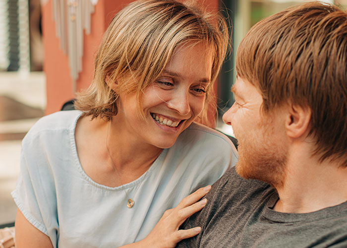 Smiling couple sharing an intimate moment, embodying marriage hacks through connection and joy.