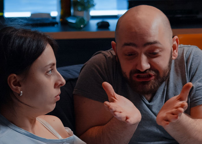 A couple having a serious conversation, illustrating a wild marriage hack in a domestic setting.