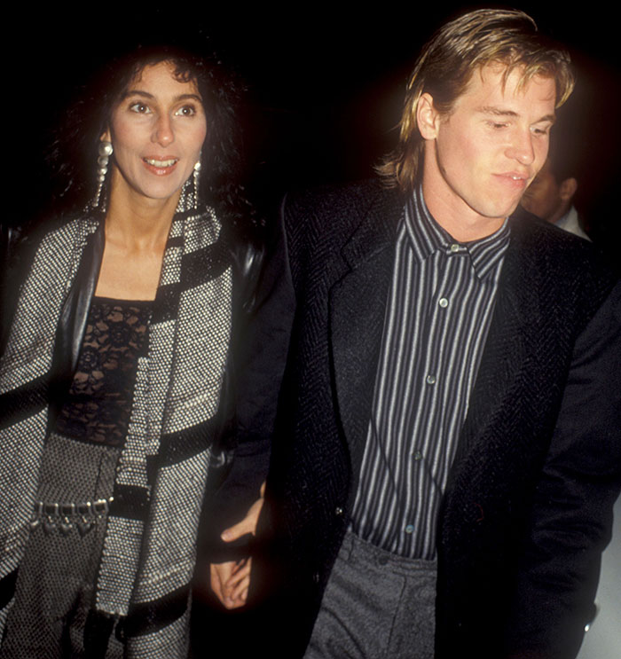 Hollywood actor with a woman, both in formal attire, attending an event, highlighting his past dating life.