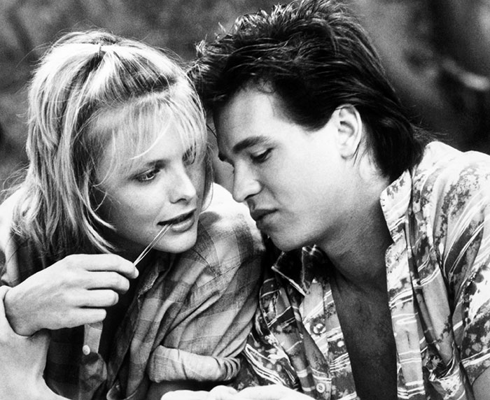 A couple sitting close together, sharing an intimate moment, highlighting the theme of loneliness despite past relationships.