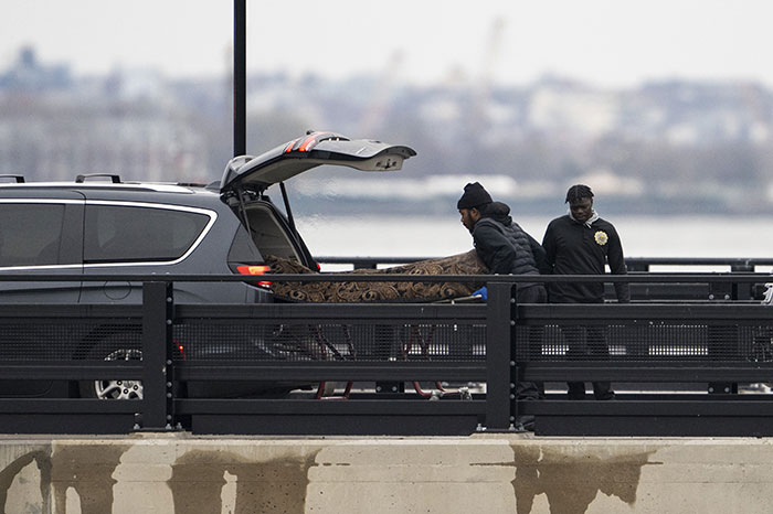 Responders load a stretcher into an SUV following a New York helicopter crash involving tech boss's family.