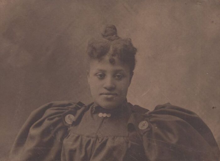 Vintage portrait of African American woman showcasing strength and resilience over a century ago in historical photography.
