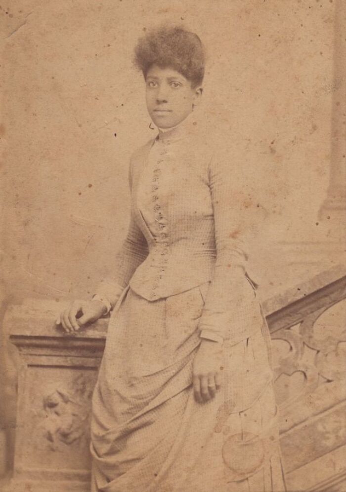 African American woman over a century ago posing confidently in vintage attire showing strength and resilience.