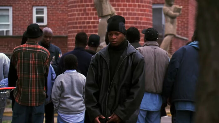 People gathered in urban setting, featuring a young man in a black jacket and beanie, related to top-rated show discussion.