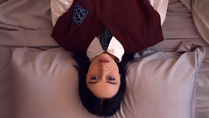 Person lying on a bed in a uniform with a patch, related to a top-rated show discussion.
