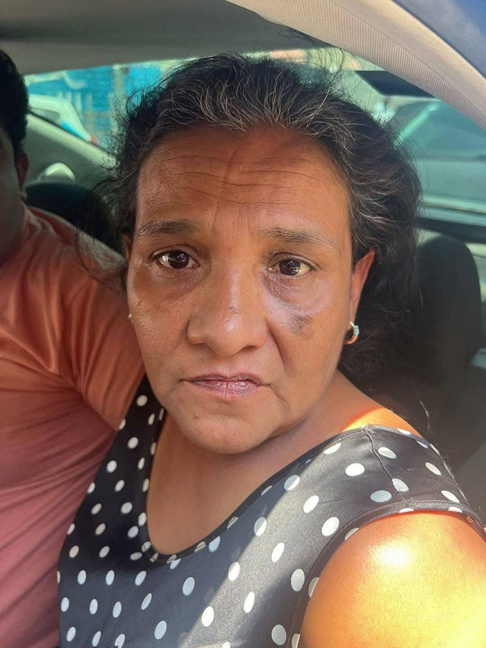 Elderly woman in a polka dot dress seated in a car, embodying a vigilant demeanor. Elderly woman in a polka dot dress seated in a car, embodying a vigilant demeanor.