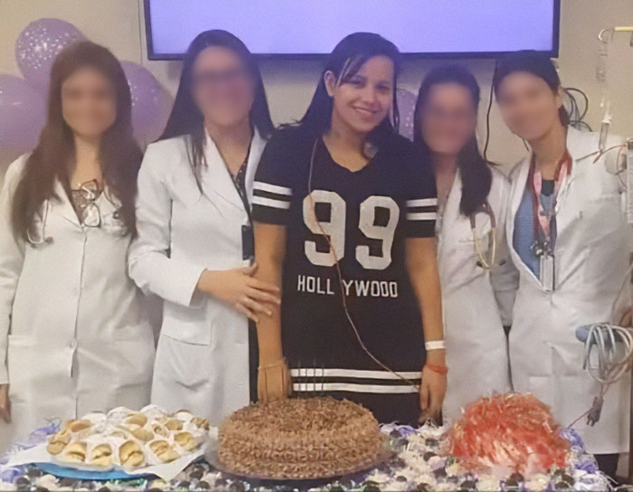 Med students pose with a patient celebrating with cake and balloons. Med students pose with a patient celebrating with cake and balloons.
