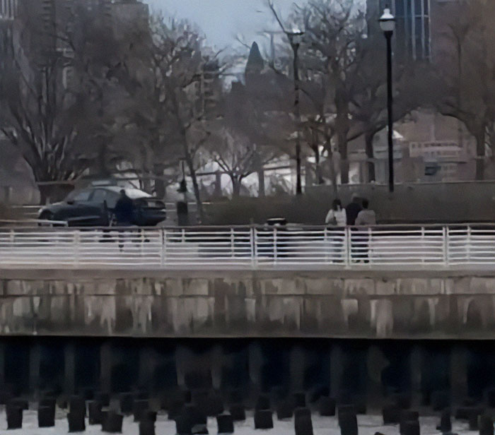 New York helicopter crash site with emergency responders on scene.