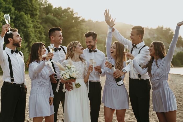 A wedding party celebrates with champagne outdoors, sparking controversy over dry weddings. A wedding party celebrates with champagne outdoors, sparking controversy over dry weddings.