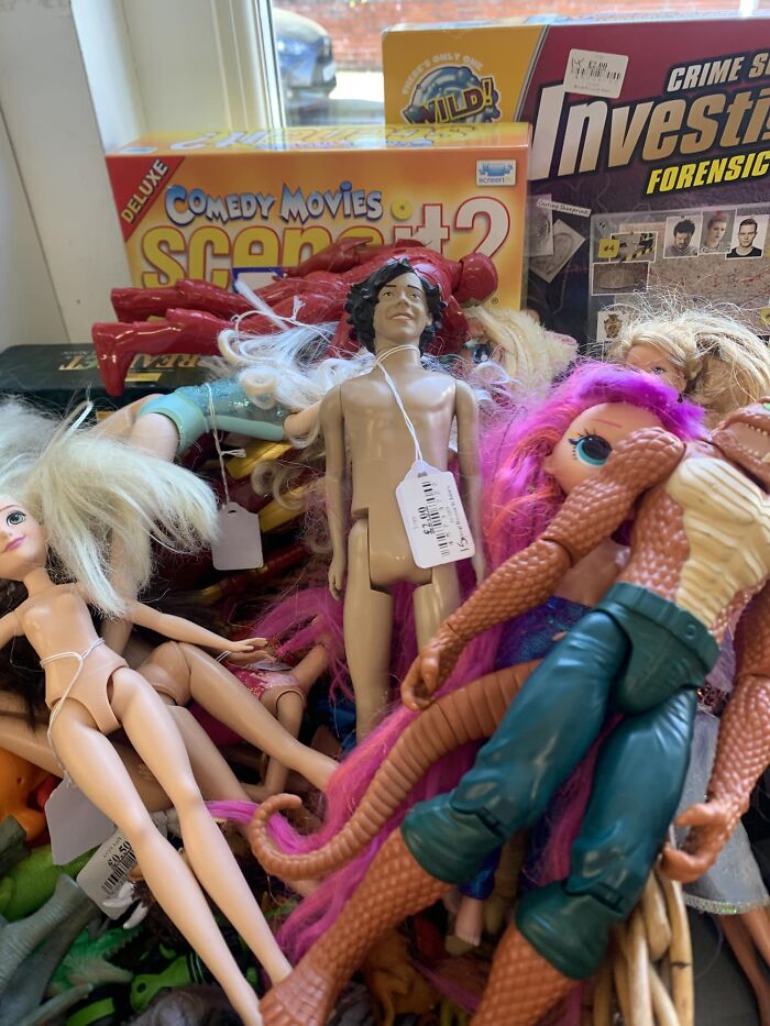 Peculiar secondhand shop treasures; various dolls and toys in a jumble.
