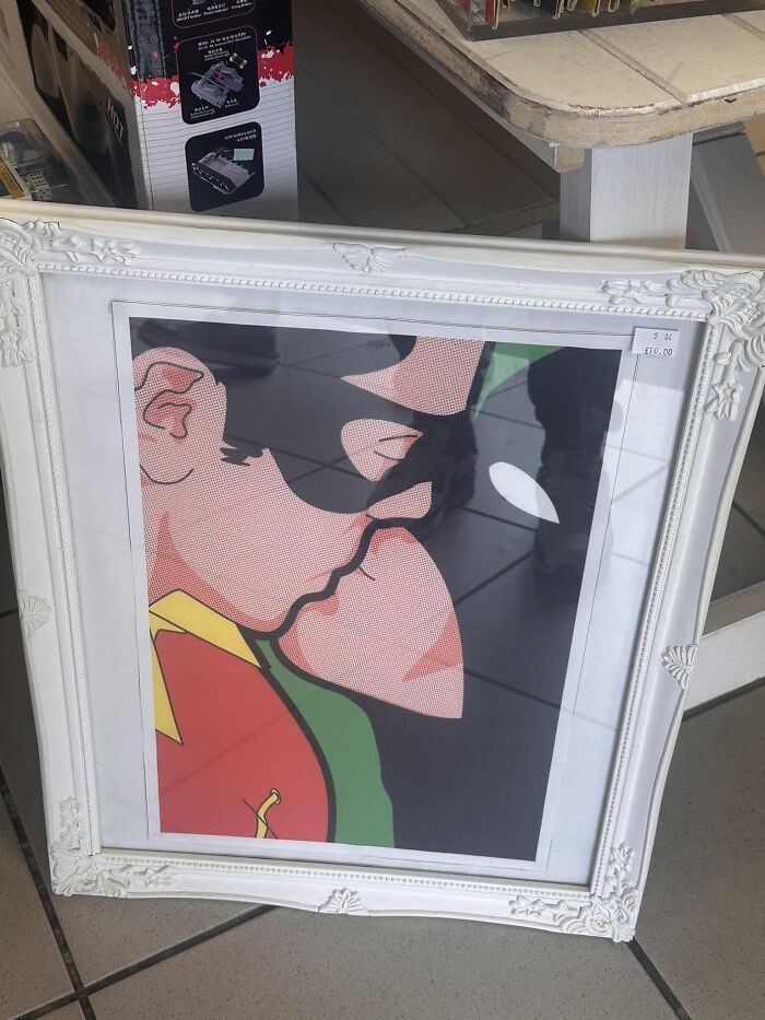 Framed pop art depicting superheroes found as a bizarre treasure in secondhand shop.