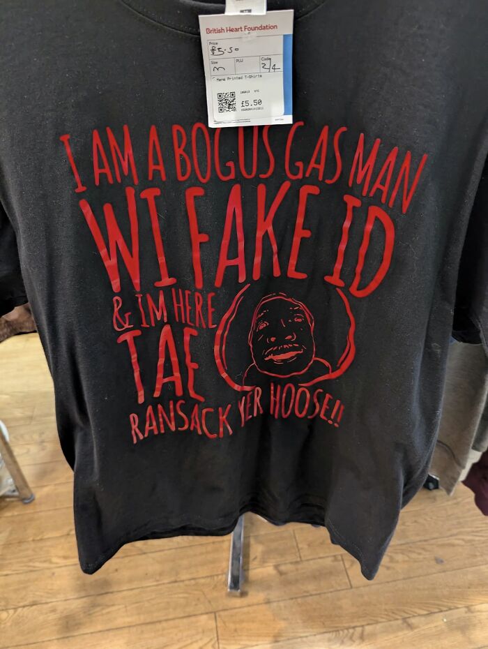 Black T-shirt with humorous "bogus gas man" design found in secondhand shop, displays quirky and bizarre treasure.