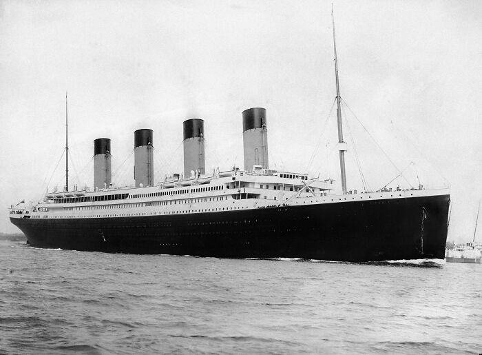 A vintage image of a large ocean liner with four smokestacks sailing on the sea, embodying random knowledge.