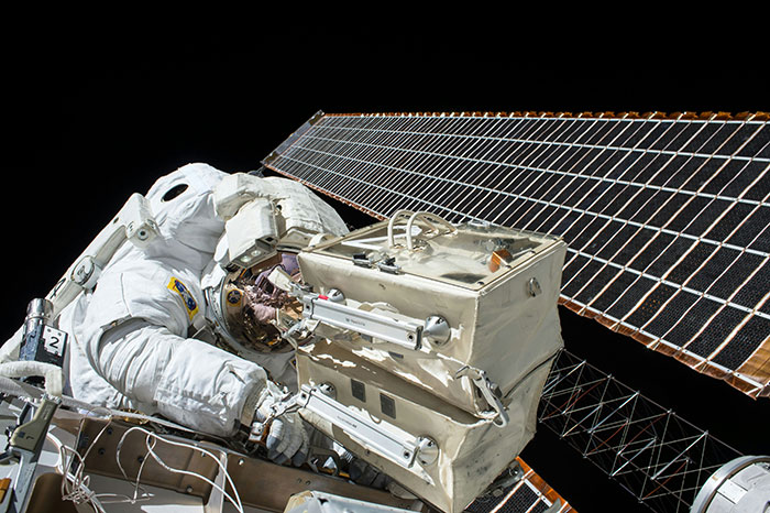 Astronaut working on space station solar panel, illustrating fascinating science facts about space exploration.