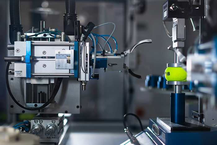 Industrial machine in a laboratory setting demonstrating a science experiment.