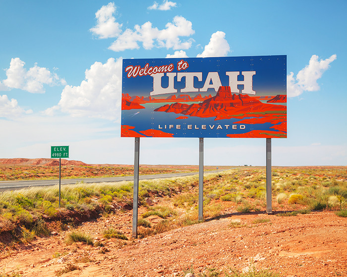 Welcome to Utah sign with desert landscape and blue sky. Welcome to Utah sign with desert landscape and blue sky.